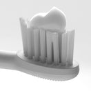 Close up of White Ordo Sonic+ Brush Head with Complete Care Toothpaste on the bristles